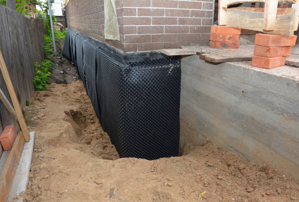 SJ Waterproofing Pros technician performing targeted Basement Waterproofing assessment in North Greece, NY